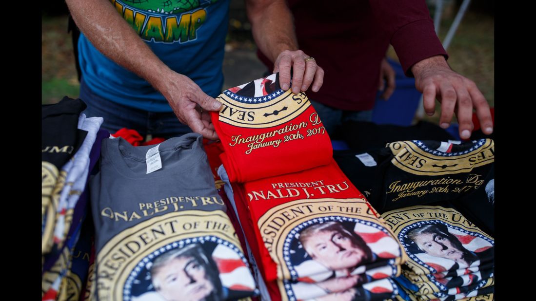 Brad White of White Hot Tees sets out inauguration-themed shirts at his stand outside the stadium. Trump will be sworn in as the 45th President of the United States on January 20.