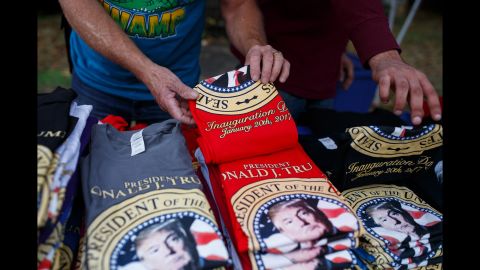 Brad White of White Hot Tees sets out inauguration-themed shirts at his stand outside the stadium. Trump will be sworn in as the 45th President of the United States on January 20.