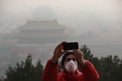 A tourist takes a selfie in Beijing on Saturday, December 17.