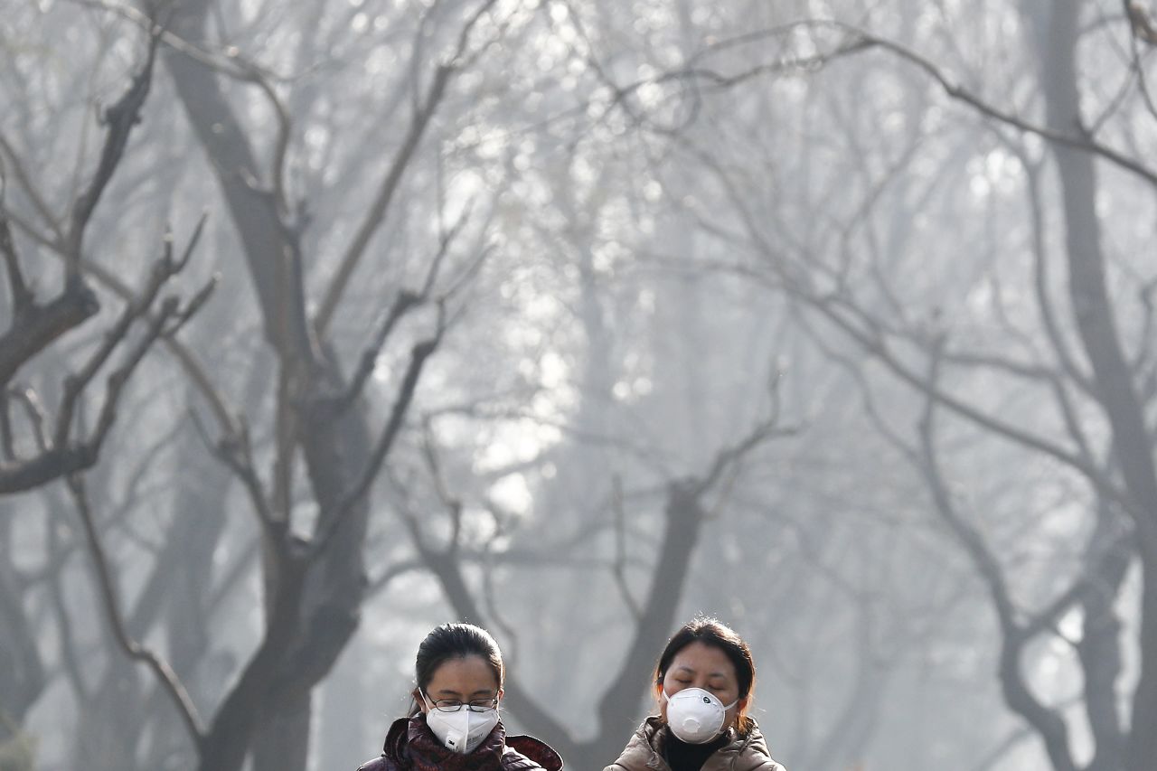 Women walk through Beijing's Ritan Park on December 19.
