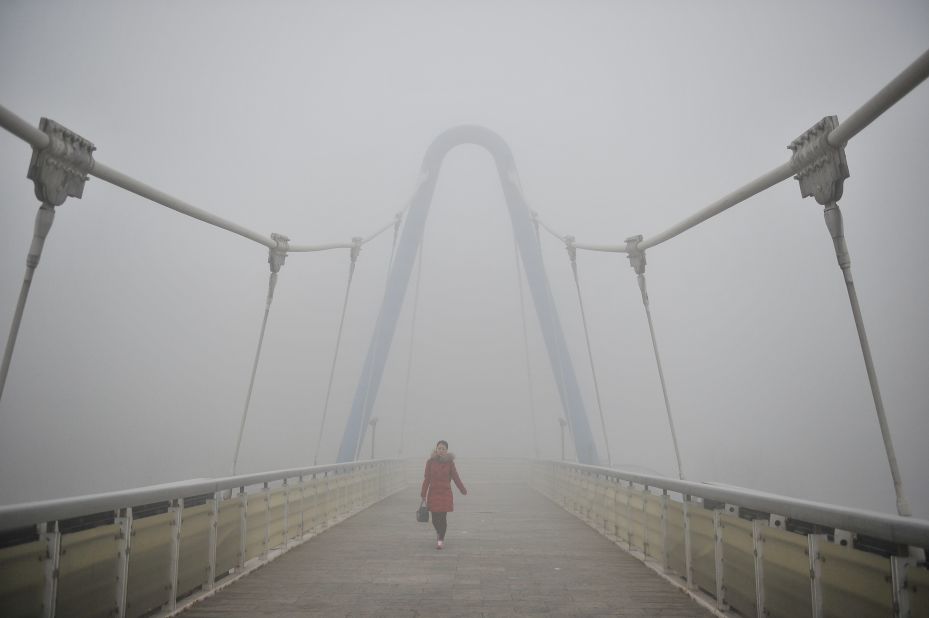 A pedestrian walks on an overpass in Tianjin, China, on December 19.