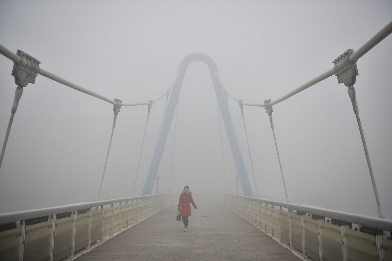 A pedestrian walks on an overpass in Tianjin, China, on December 19.