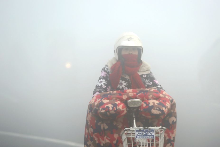 A cyclist rides in heavy smog in Lianyungang, China, on December 19.