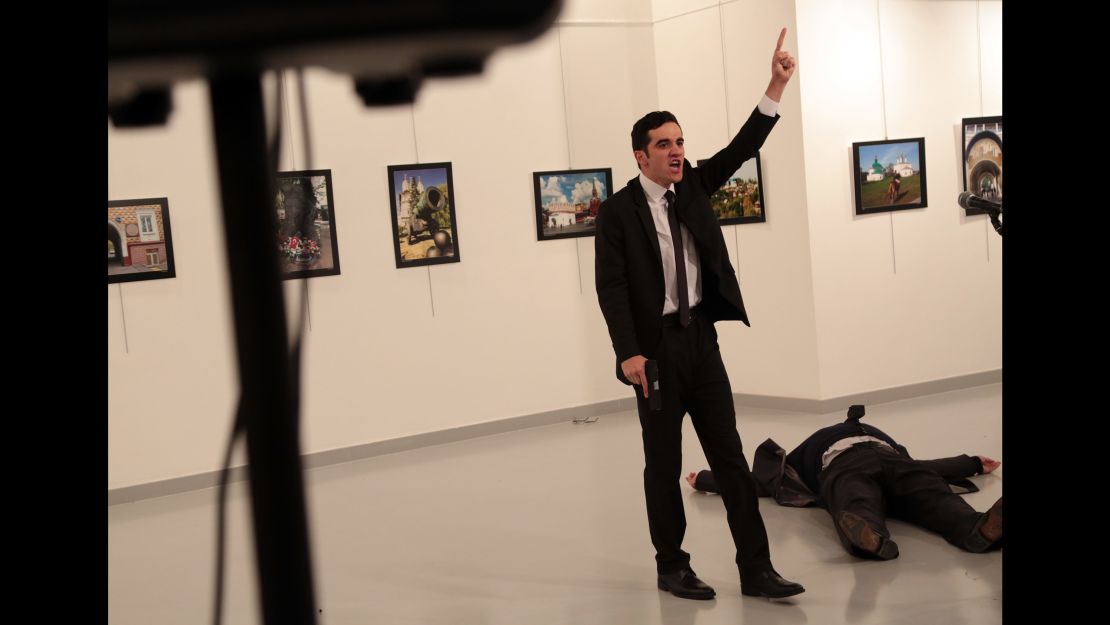 Karlov lies on the ground as a man with a pistol -- later identified as police officer Mevlut Mert Altintas -- gestures at the scene on December 19.