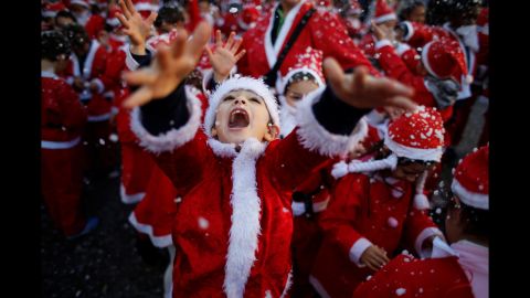 <strong>December 12:</strong> Children dressed as Santa Claus participate in a parade that collected food for the needy in Lisbon, Portugal.