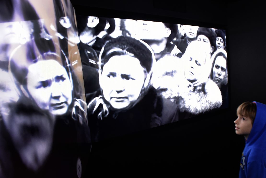 A visitor examines the multimedia displays showing Stalin's funeral during the opening ceremony of a new museum dedicated to the Soviet Gulag labour camp system in 2015.