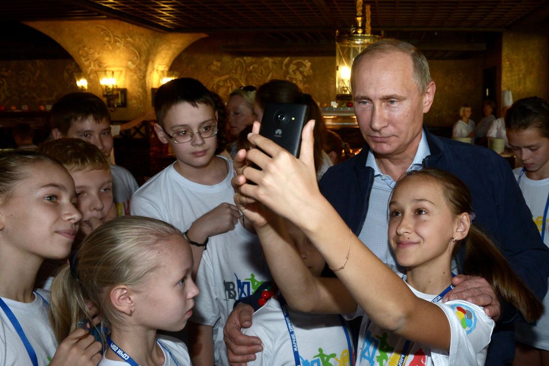 Putin poses for selfie during his visit to the National Children's Sports and Health Centre in Sochi on October 11, 2014. 