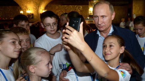 Putin poses for selfie during his visit to the National Children's Sports and Health Centre in Sochi on October 11, 2014. 