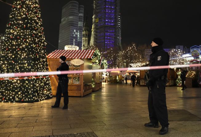 Police stand guard at the market after the crash.