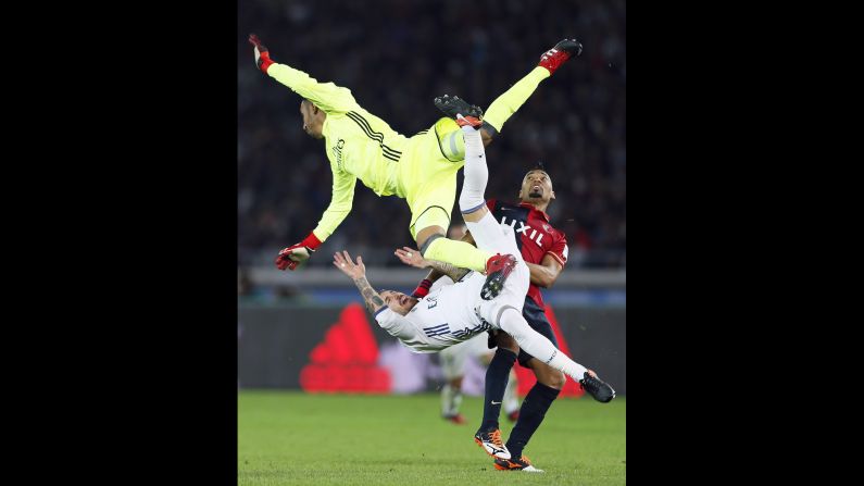Real Madrid goalkeeper Keylor Navas collides with teammate Sergio Ramos, bottom, and Kashima Antlers midfielder Fabricio during the final of the FIFA Club World Cup on Sunday, December 18. <a href="index.php?page=&url=http%3A%2F%2Fwww.cnn.com%2F2016%2F12%2F18%2Ffootball%2Ffootball-world-club-real-antlers-ronaldo%2Findex.html" target="_blank">Madrid won 4-2</a> in Yokohama, Japan. 