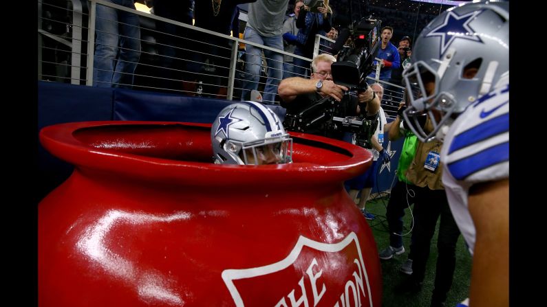 Dallas running back Ezekiel Elliott celebrates a touchdown by jumping into a big Salvation Army kettle on Sunday, December 18. Elliott rushed for a career-high 159 yards as the Cowboys beat Tampa Bay 26-20.