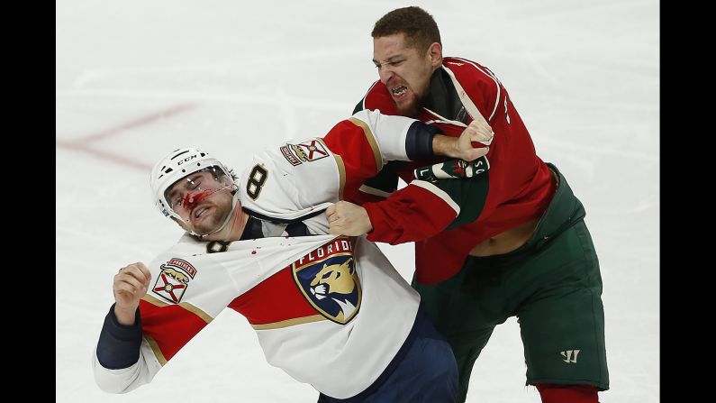Florida's Dylan McIlrath, left, and Minnesota's Chris Stewart brawl during an NHL game in St. Paul, Minnesota, on Tuesday, December 13.