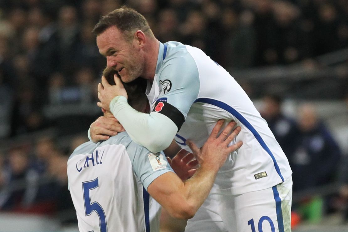 England captain Wayne Rooney celebrates after defender Gary Cahill (left) scores against Scotland.