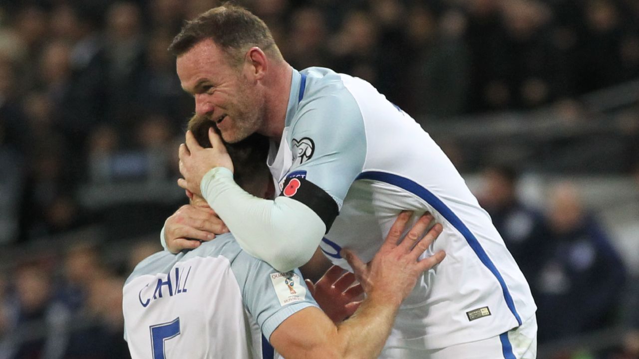 England captain Wayne Rooney celebrates after defender Gary Cahill (left) scores against Scotland.