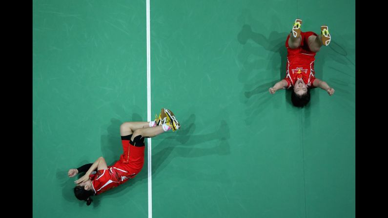 Chinese badminton players Chen Qingchen and Jia Yifan celebrate Sunday, December 18, after winning the Super Series doubles final in Dubai, United Arab Emirates.