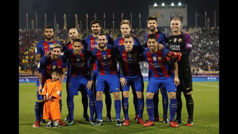Murtaza Ahmadi, the Afghan boy <a href="index.php?page=&url=http%3A%2F%2Fwww.cnn.com%2F2016%2F12%2F13%2Fsport%2Flionel-messi-meets-murtaza-ahmadi%2F" target="_blank">who gained online fame</a> after a picture of him wearing a makeshift Lionel Messi jersey went viral, poses with Messi and the rest of the Barcelona starting 11 before a match in Doha, Qatar, on Tuesday, December 13. Barcelona was playing a friendly match against Saudi champions Al-Ahli.