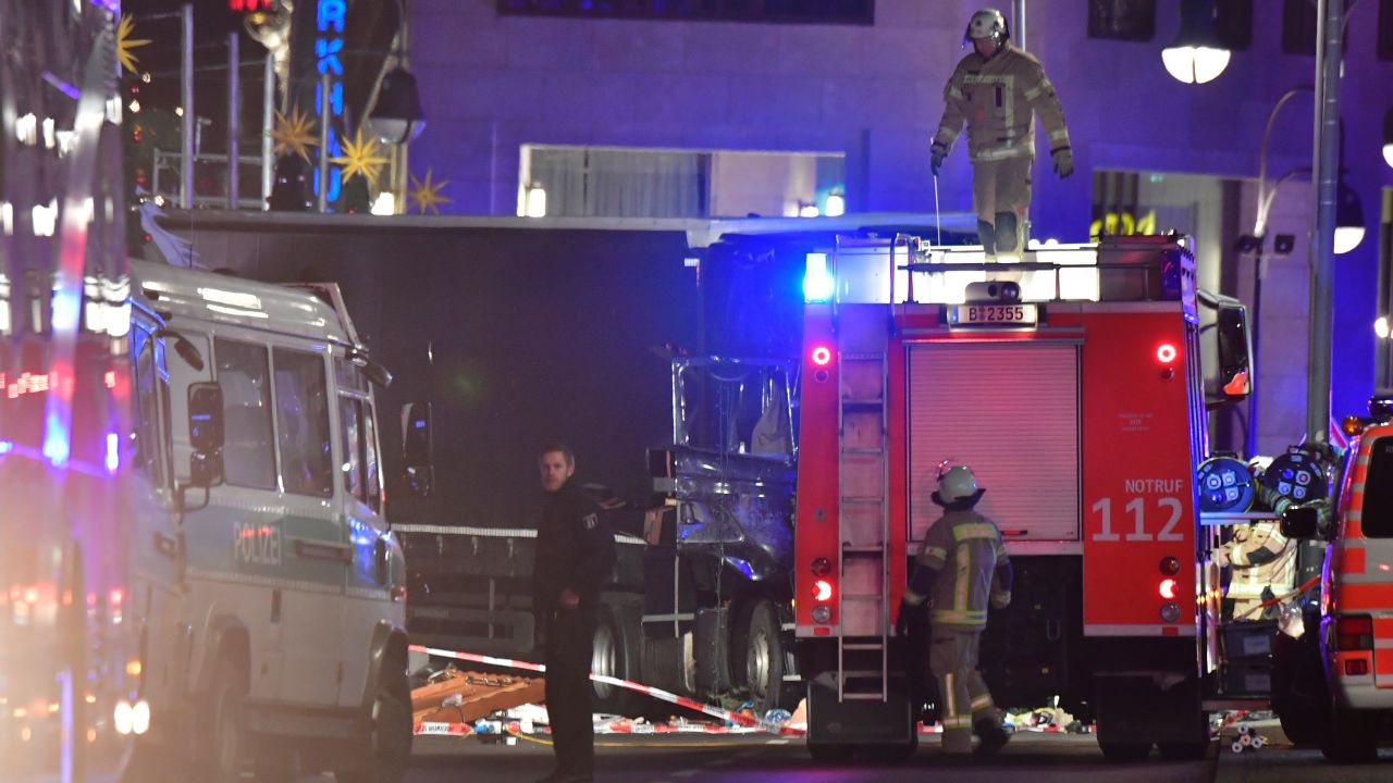 Rescue forces stand in front of the truck that speed into a Christmas market in Berlin, on December 19, 2016 killing nine persons and injuring at least 50 people.
Ambulances and police rushed to the scene after the driver drove up the pavement of the market in a central square popular with tourists less than a week before Christmas, in a scene reminiscent of the deadly truck attack in Nice. 