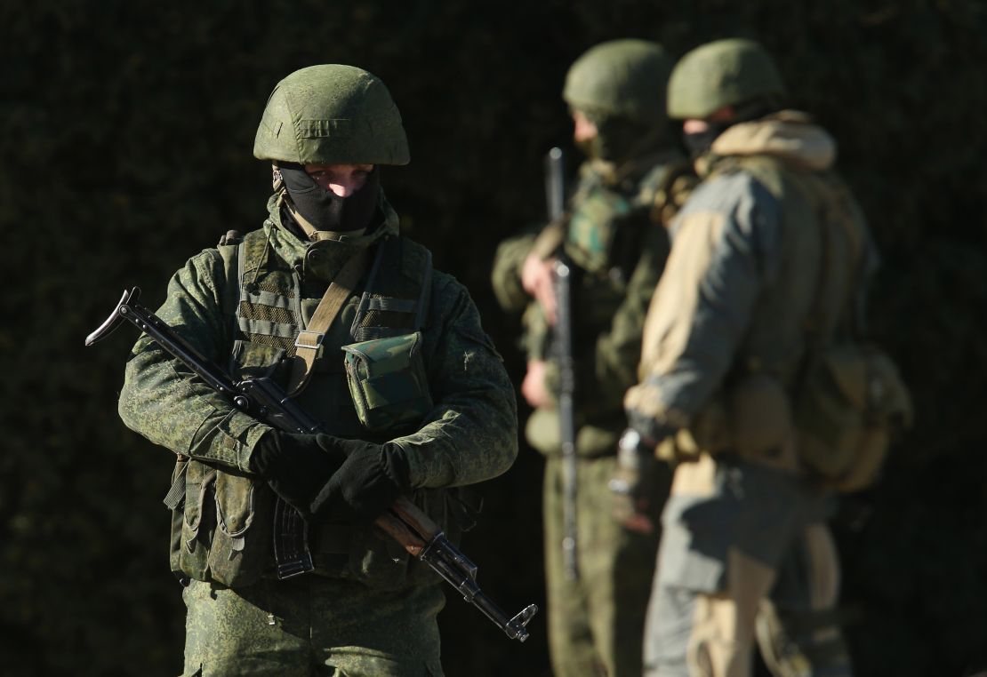 Armed men wearing no identifying insignia guard a government building on March 3, 2014, in Simferopol, Ukraine.