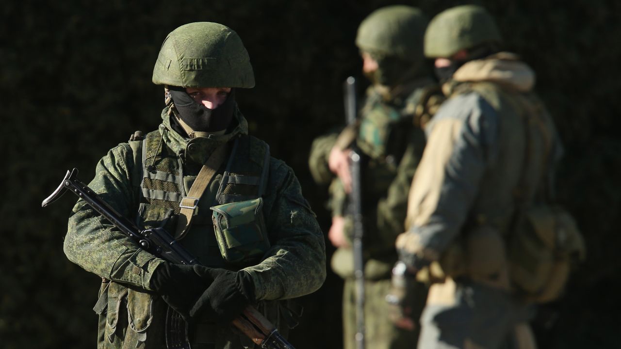 Armed men wearing no identifying insignia guard a government building on March 3, 2014, in Simferopol, Ukraine.