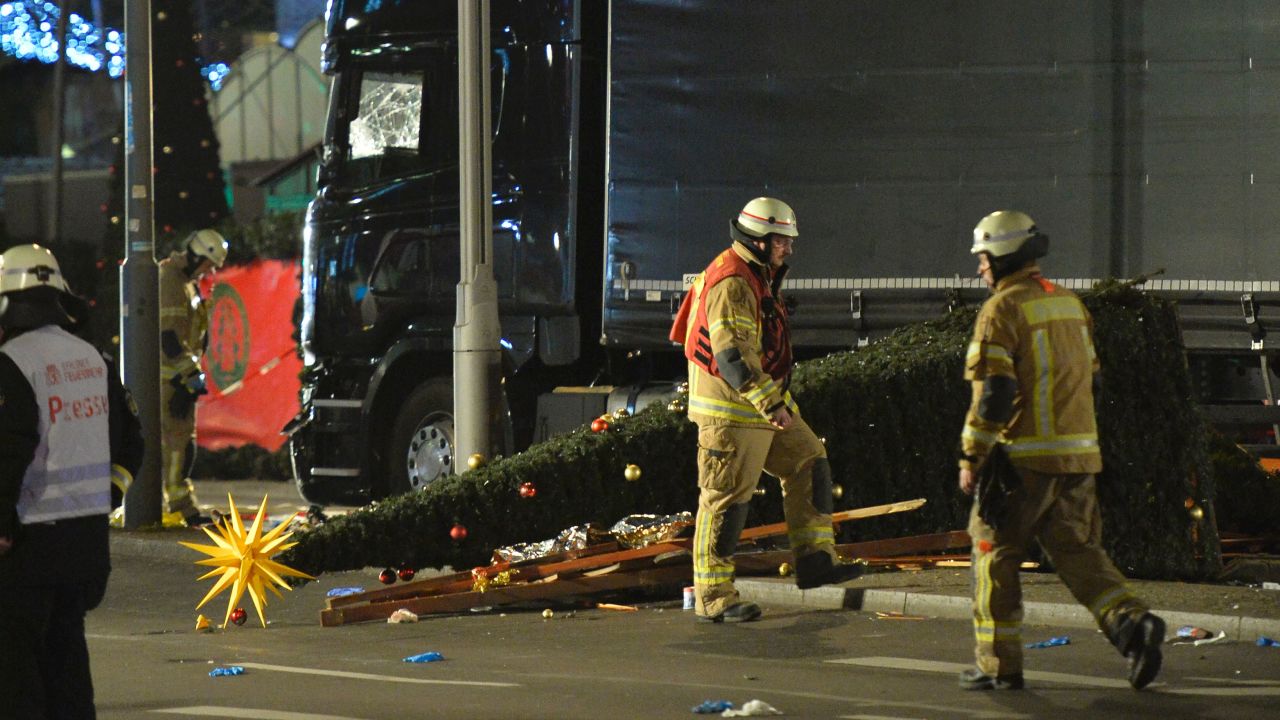 A Christmas tree lies next to a truck that slammed into a Christmas market at Gedächniskirche church. 
 