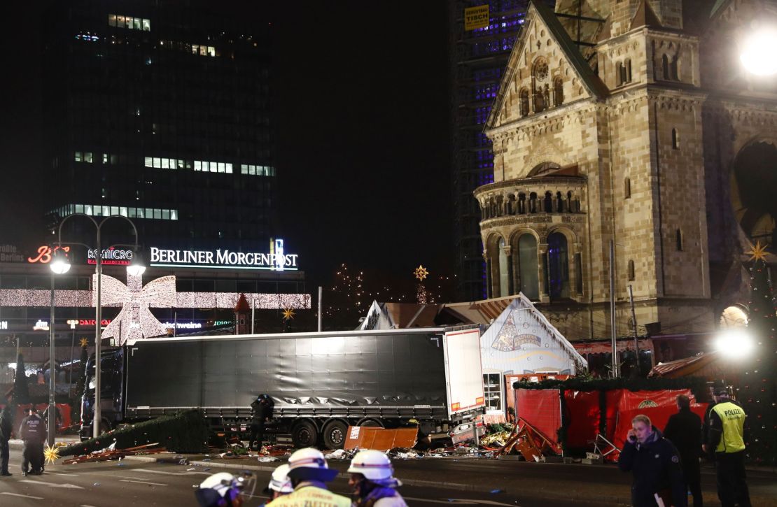 Policemen guard a truck that crashed into a Christmas market in Berlin, on December 19, 2016.