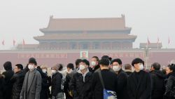 BEIJING, CHINA - DECEMBER 18:  Tourists wearing masks visit the Tiananmen Square on December 18, 2016 in Beijing, China. At least 24 cities in North China issued red alerts on Friday as heavy smog will shroud the country's northern regions in the following two days.  (Photo by VCG/VCG via Getty Images)