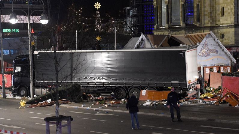 Police officers stand next to the truck.