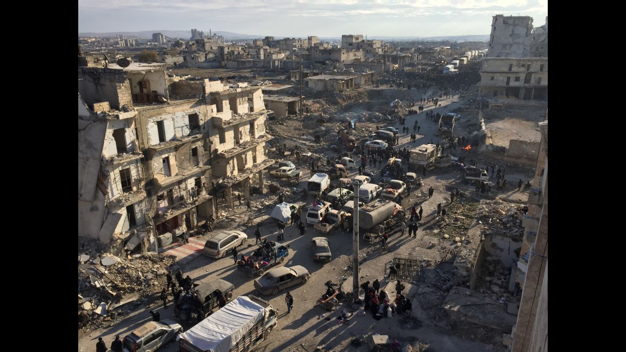 Civilians wait to be bussed out of besieged areas of eastern Aleppo, Syria, as evacuations continue on Monday, December 19. A people-swap deal struck between rebels and Syrian government forces was set to begin over the weekend, but evacuations were temporarily put on hold after a number of buses were set on fire.