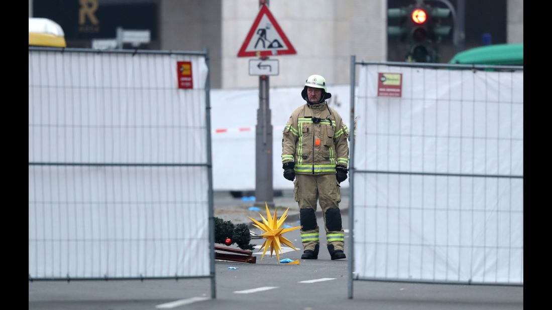 A rescue worker stands beside Christmas decorations that were scattered by the crash.