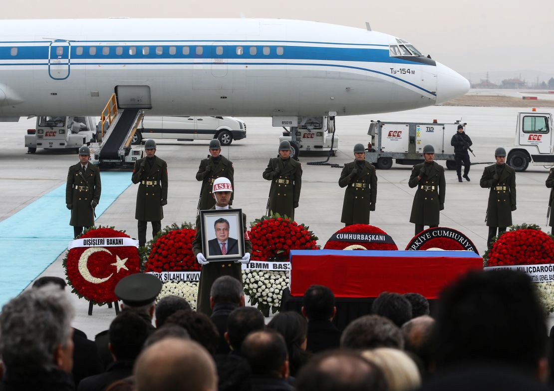 Turkish soldiers stand near the coffin of the Russian ambassador Tuesday at the Ankara airport.