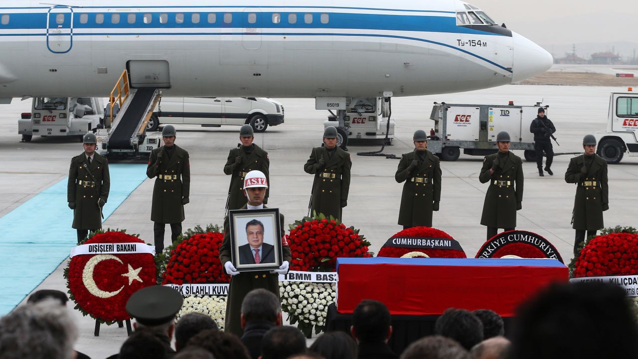 Turkish soldiers stand near the coffin of the Russian ambassador Tuesday at the Ankara airport.