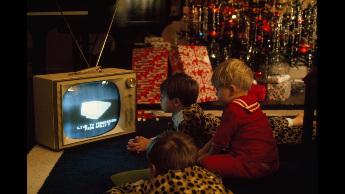 Boys in Virginia watch the Christmas Eve broadcast of Apollo 8, which orbited the moon in December 1968. Apollo 8 marked the first time that humans had ever left Earth's gravity. An estimated 1 billion viewers in 64 countries watched as the NASA spacecraft beamed back live images of the lunar surface.