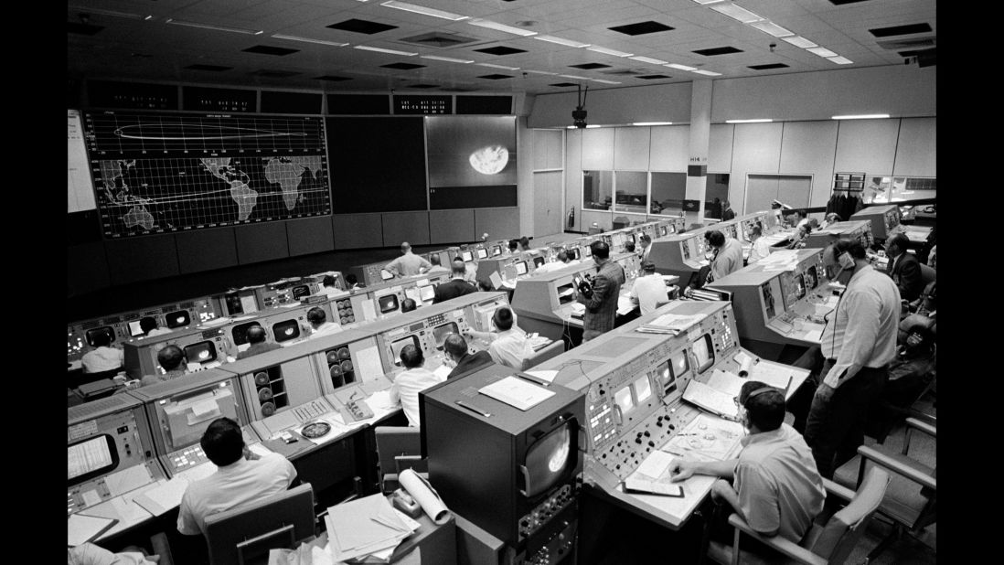 NASA's Mission Control Center in Houston on the third day of the mission. Seen on the TV monitor is a picture of Earth that Apollo 8 sent from 176,000 miles away.