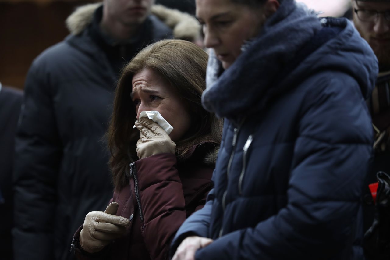 A woman reacts near the crime scene on December 20.