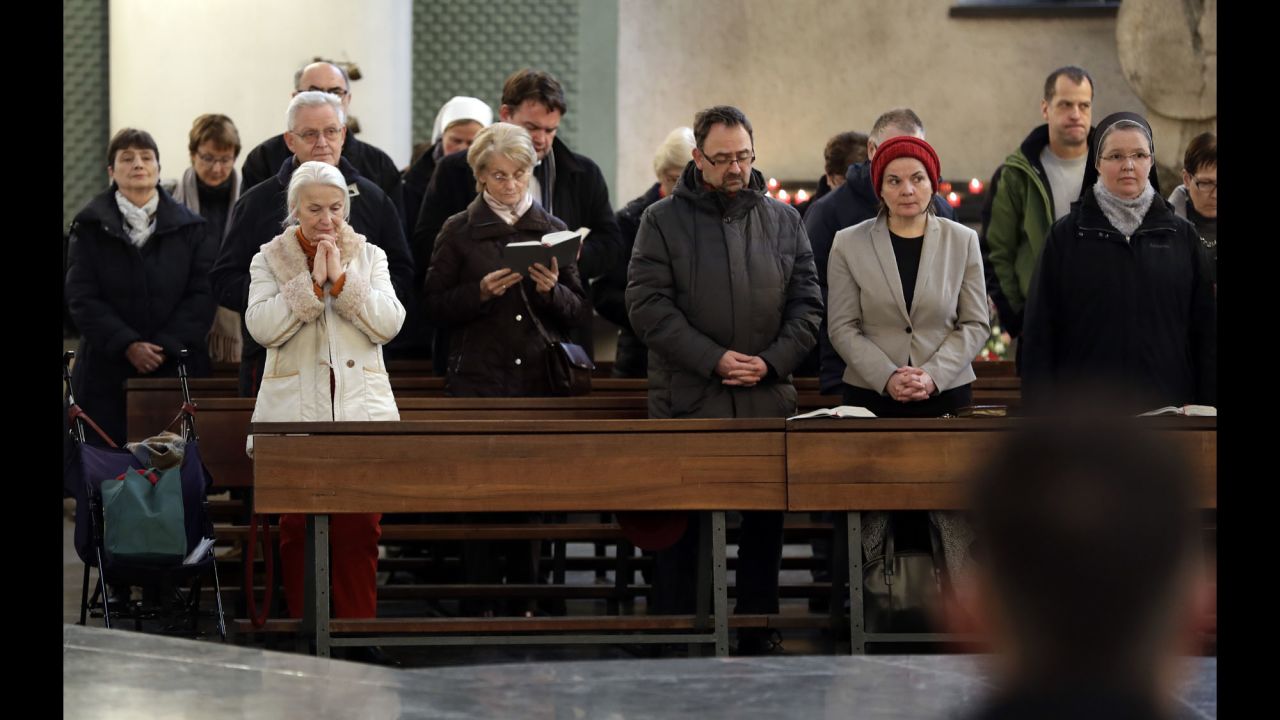 People attend a memorial service at St. Hedwig Cathedral in Berlin on December 20.
