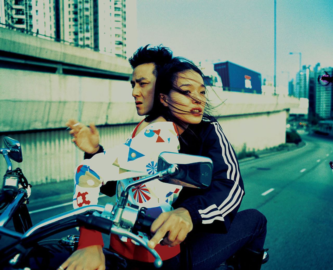 After working for Wong Kar Wai, Wing spent years shooting editorials for fashion magazine i-D. In this classic image, actress Shu Qi rides atop a motorcycle piloted through Hong Kong by Daniel Wu -- a cross-processed fantasy of youthful anomie.