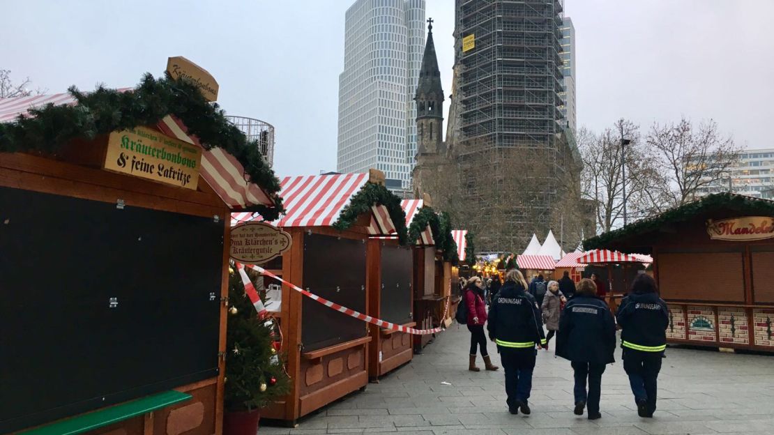 Security services patrol the boarded up Christmas stalls.