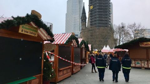 Security services patrol the boarded up Christmas stalls.