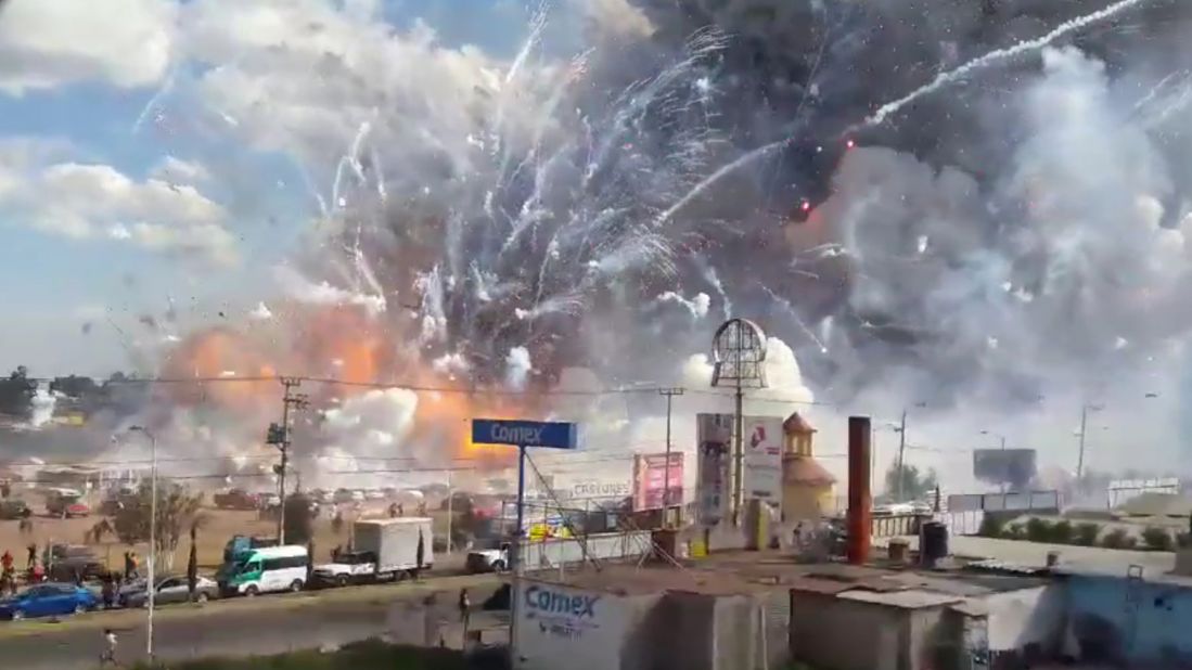 Fireworks explode from the San Pablito market in Tultepec, Mexico, on Tuesday, December 20. Authorities say dozens were killed in blasts at the market, which was especially busy with people buying fireworks for the holidays.