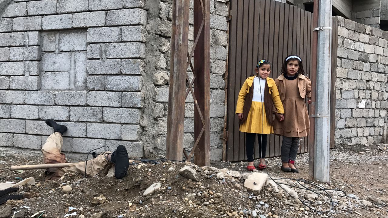 These girls see this body of a fallen ISIS fighter whenever they leave their house.