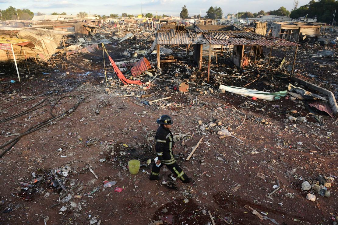Firefighters work amid the debris of the blast at the San Pablito market near Mexico City 