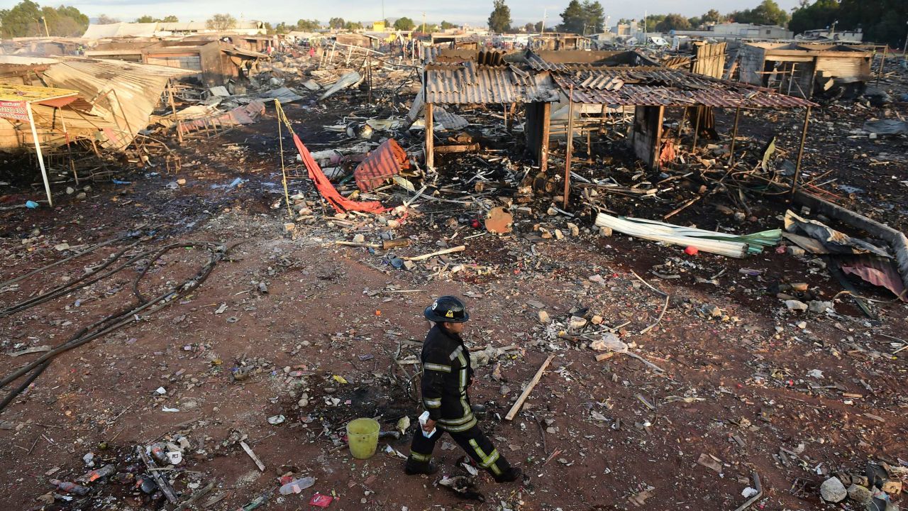 Firefighters work amid the debris of the blast at the San Pablito market near Mexico City