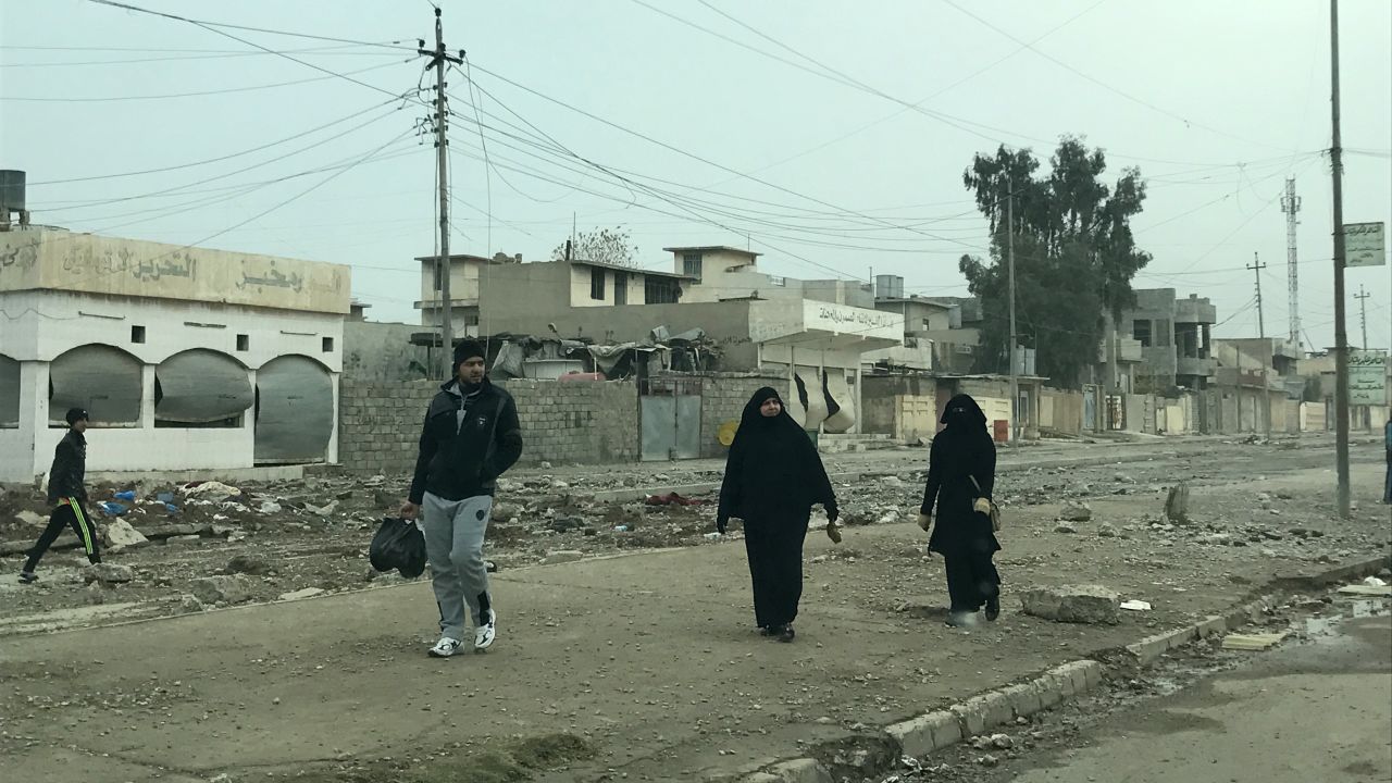 Residents walk in al-Samah neighborhood in liberated areas in eastern Mosul. Many women were seen uncovering their faces, one of many things they could not do under the control of ISIS.