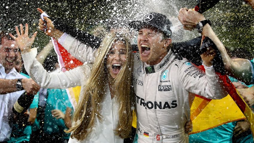 ABU DHABI, UNITED ARAB EMIRATES - NOVEMBER 27:  Nico Rosberg of Germany and Mercedes GP celebrates with his wife Vivian Sibold and his team after finishing second and securing the F1 World Drivers Championship at the Abu Dhabi Formula One Grand Prix at Yas Marina Circuit on November 27, 2016 in Abu Dhabi, United Arab Emirates.  (Photo by Clive Mason/Getty Images)