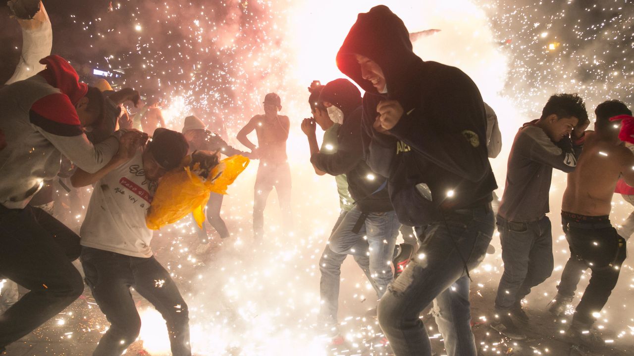 Crowds jump around as rockets rain down at the National Pyrotechnic Festival in Tultepec in March.
