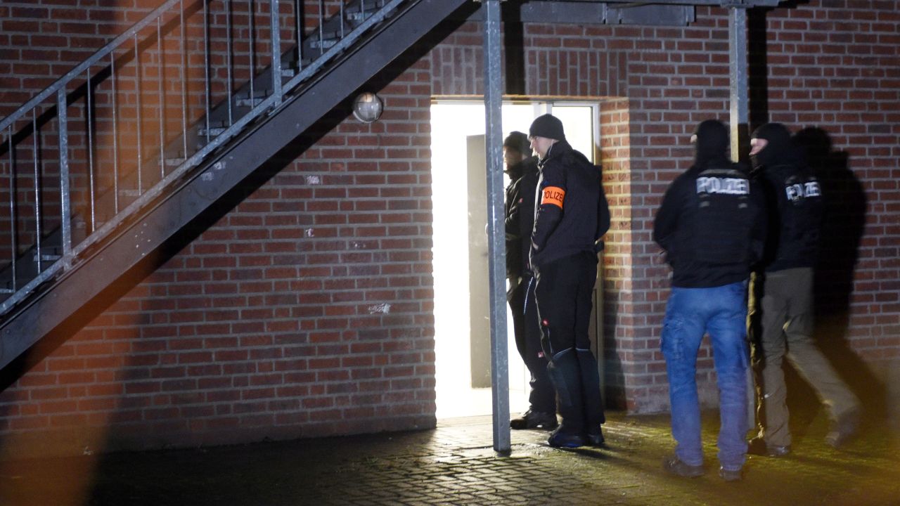 Police officers enter a refugee shelter Thursday in Emmerich, Germany.