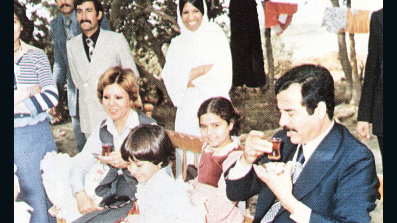 In this undated photo, Saddam Hussein, his daughters Ragad and Rana, and first wife Sajida during a visit with family friends on the outskirts of Baghdad.
