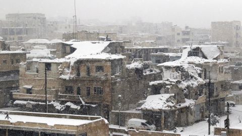 TOPSHOT - A picture shows ruins covered in snow in the town of Maaret al-Numan, in Syria's northern province of Idlib, on December 21, 2016.
Rebels and civilians who have sought refuge in the opposition-held province of Idlib, most recently from second city Aleppo, say they are suffering from skyrocketing prices and overpopulation. At least 25,000 people, including rebel fighters, have left east Aleppo since last week under an evacuation deal that will see the city come under full government control.
/ AFP / Mohamed al-Bakour (Photo credit should read MOHAMED AL-BAKOUR/AFP/Getty Images)