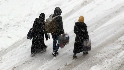 Displaced Syrians trudge through the snow with their belongings this week in Idlib province.