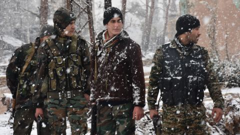 Snow falls on pro-government forces Wednesday in Aleppo. 